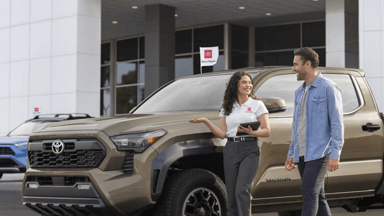 Toyota Sales Associate showing a Toyota Tacoma to a customer