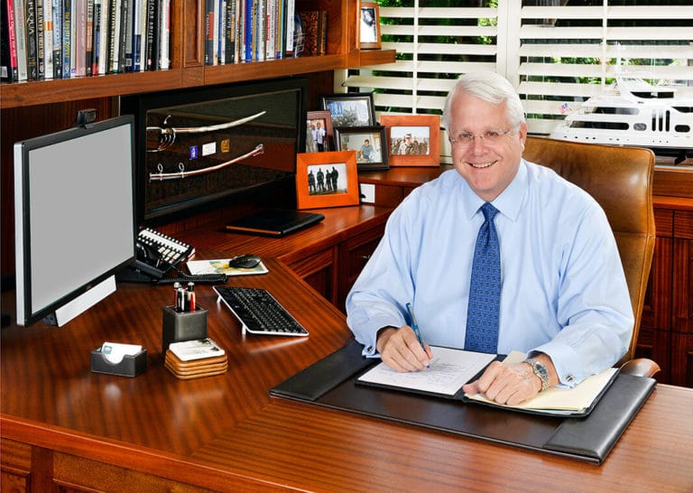 Colin Brown sitting at his desk