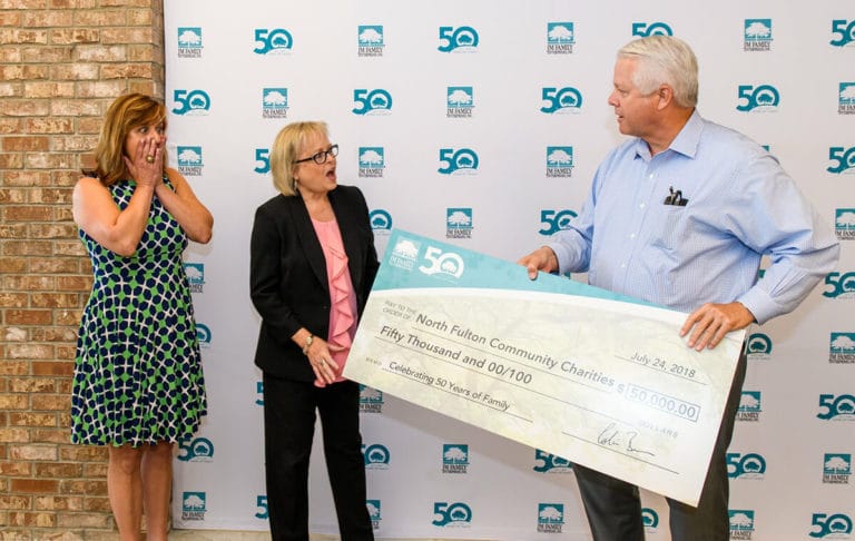 Colin Brown giving a big check to North Fulton Community Charities in 2018 Colin Brown giving a big check to North Fulton Community Charities in 2018