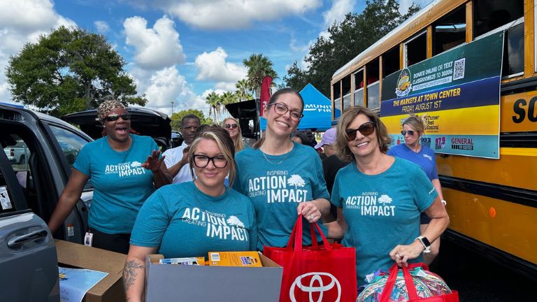 Associates volunteering at a stuff-the-bus event.