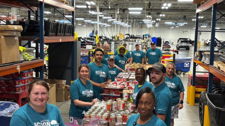 Associates packing grocery items during a food drive.